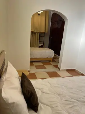 a bedroom with a bed and a hallway with a mirror at Habibi Riad&Hostel in Marrakech