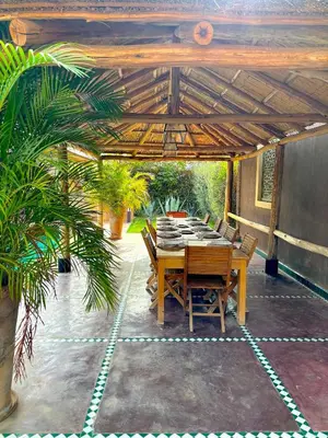 a wooden table and chairs on a patio at Palais Mars in Marrakech