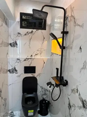 a bathroom with a toilet and a lamp on a wall at Superbe appartement à Marrakech in Marrakech