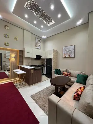 a living room with a couch and a kitchen at Superbe appartement à Marrakech in Marrakech