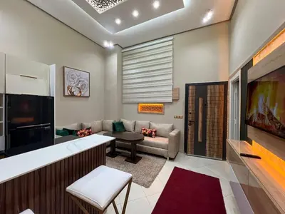 a living room with a couch and a tv at Superbe appartement à Marrakech in Marrakech