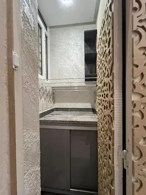 a walk in shower in a bathroom with a wall at Superbe appartement à Marrakech in Marrakech