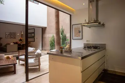 a kitchen with a counter and a living room at Riad 17 DAR CHAMAR in Marrakech