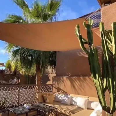 a patio with a couch and a cactus at Riad 17 DAR CHAMAR in Marrakech