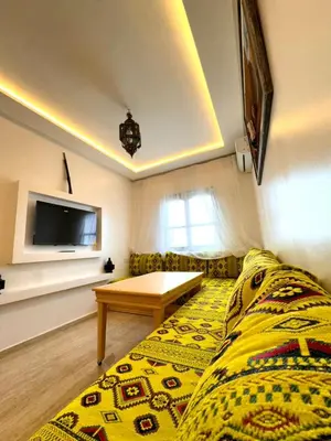 a living room with a couch and a table at cosy appartement a marrakech in Marrakech