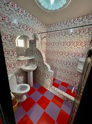 a bathroom with a red and white checkered floor at Riad mostafa in Marrakech