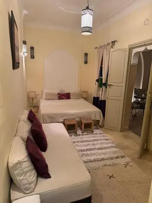 a living room with two beds and a couch at Riad Lou Kasbah in Marrakech
