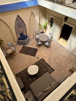 an overhead view of a patio with a table and chairs at Riad Lou Kasbah in Marrakech