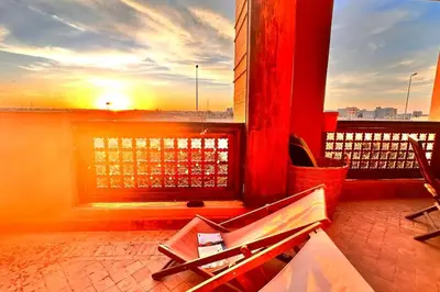 a view of a sunset from a balcony at Marrakech flat with swimming pool & sunny garden in Marrakech