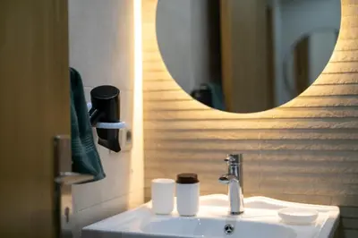 a bathroom with a sink and a mirror at Chic urbain en plein centre in Marrakech