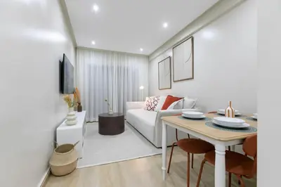 a living room with a white couch and a table at Chic urbain en plein centre in Marrakech