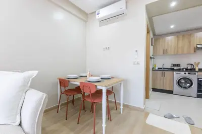 a small kitchen with a table and chairs in a room at Chic urbain en plein centre in Marrakech