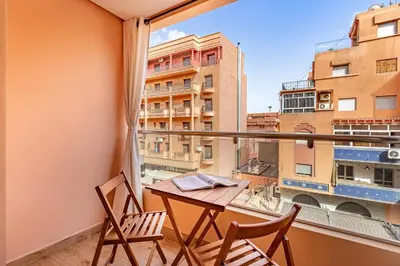 a balcony with a table and two chairs and a window at appt élégant et confort dans le centre de Marrakech in Marrakech