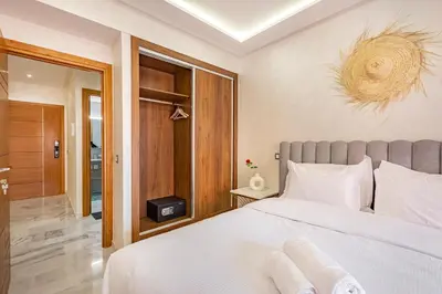 a bedroom with a large white bed in a room at appt élégant et confort dans le centre de Marrakech in Marrakech