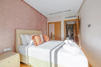 a bedroom with two beds in a room at Best location new appart café de la poste Plaza in Marrakech