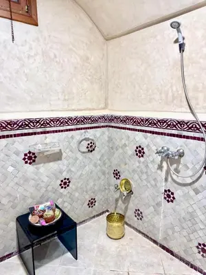 a bathroom with a shower and a plate of food on a table at Medley Luxury Villa - PARKING, WIFI & PISCINE in Marrakech