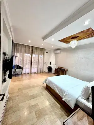 a large bedroom with a bed and a fireplace at Medley Luxury Villa - PARKING, WIFI & PISCINE in Marrakech