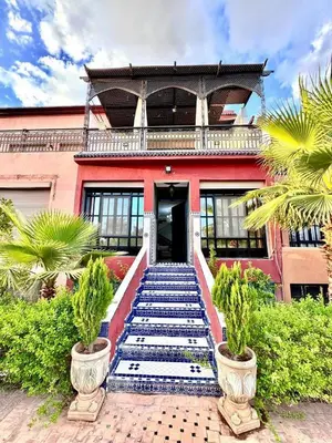 a building with a staircase in front of a building at Medley Luxury Villa - PARKING, WIFI & PISCINE in Marrakech
