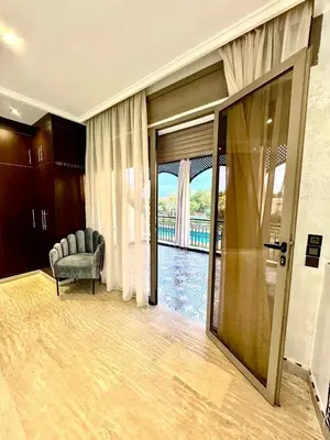 a living room with a sliding glass door to a balcony at Medley Luxury Villa - PARKING, WIFI & PISCINE in Marrakech