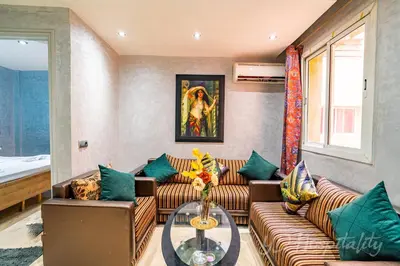 a living room with couches and a table at 5-Star Atlas Pearl well Centered in Marrakech