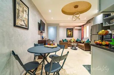 a kitchen and living room with a table and chairs at 5-Star Atlas Pearl well Centered in Marrakech