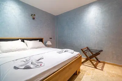 a bedroom with a large bed with white sheets at 5-Star Atlas Pearl well Centered in Marrakech