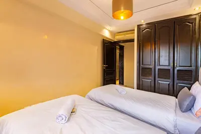 two beds sitting next to each other in a bedroom at Coup de coeur en plein centre ville piscine in Marrakech