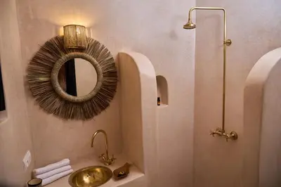 a bathroom with a sink and a mirror at Riad Tawkane in Marrakech