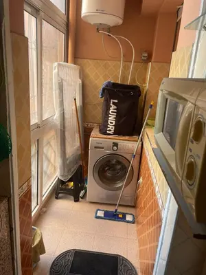 a laundry room with a washing machine and a washer at Cozy Studio center of Marrakech in Marrakech