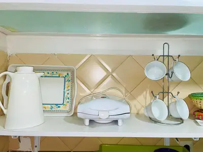 a shelf with a tea kettle and utensils on it at Cozy Studio center of Marrakech in Marrakech