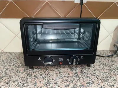 a black toaster oven sitting on top of a counter at Cozy Studio center of Marrakech in Marrakech