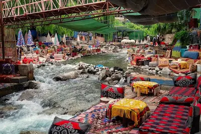 a river with tables and chairs in the middle at Cozy Studio center of Marrakech in Marrakech