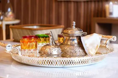 a tray with a tea kettle and glasses on a table at 2Br Apartment 15 min from Jemaa el-Fnaa Marrakech in Marrakech