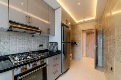 a kitchen with a stove and a refrigerator at 2Br Apartment 15 min from Jemaa el-Fnaa Marrakech in Marrakech