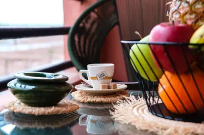 a table with a cup and a basket of fruit at 2Br Apartment 15 min from Jemaa el-Fnaa Marrakech in Marrakech
