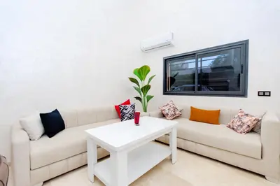 a living room with a couch and a table at Appartement Duplex Hivernage in Marrakech