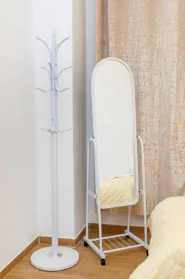 a mirror on a stand next to a bed at Appartement Duplex Hivernage in Marrakech