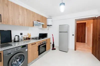 a kitchen with a refrigerator and a dishwasher at Appartement Duplex Hivernage in Marrakech