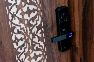a black door handle on a wooden door with a pattern at Appartement Duplex Hivernage in Marrakech
