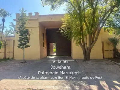a building with a tree in front of it at Villa jowehara Palmeraie Marrakech in Marrakech