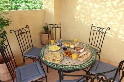 a table with a plate of food on it at Riad Bahia BenSaleh in Marrakech