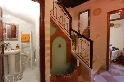 a bathroom with a staircase leading to a bathroom with a sink at Riad Bahia BenSaleh in Marrakech