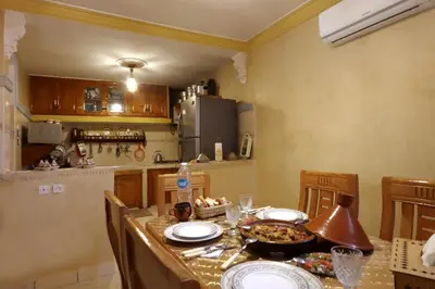 a kitchen with a table with plates of food on it at Riad Bahia BenSaleh in Marrakech