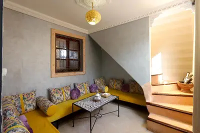 a living room with a couch and a table at Riad Bahia BenSaleh in Marrakech