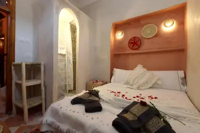 a bedroom with a bed with flowers on it at Riad Bahia BenSaleh in Marrakech