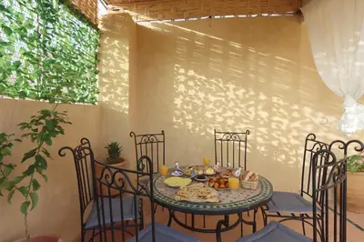 a table with a plate of food on it at Riad Bahia BenSaleh in Marrakech