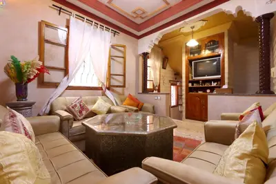 a living room with couches and a tv at Riad Bahia BenSaleh in Marrakech