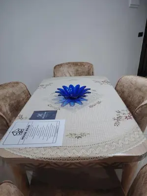 a table with a blue flower on top of it at Quiet and family apartment, appartement in Marrakech