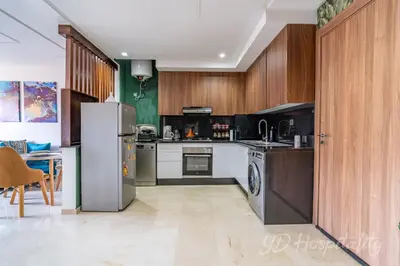 a kitchen with stainless steel appliances and wooden cabinets at 5-Star Suite in Prime Spot with Luxe Touches in Marrakech