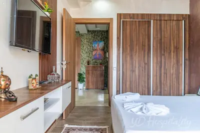 a bedroom with a large white bed and a kitchen at 5-Star Suite in Prime Spot with Luxe Touches in Marrakech